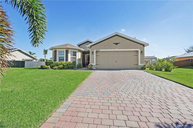 view of front of home with a front yard and a garage