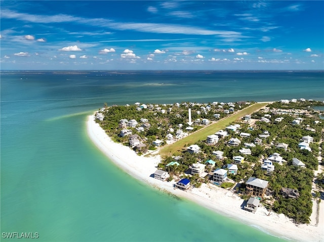 birds eye view of property featuring a water view and a view of the beach