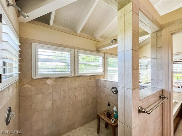 bathroom featuring walk in shower, a wealth of natural light, and tile walls