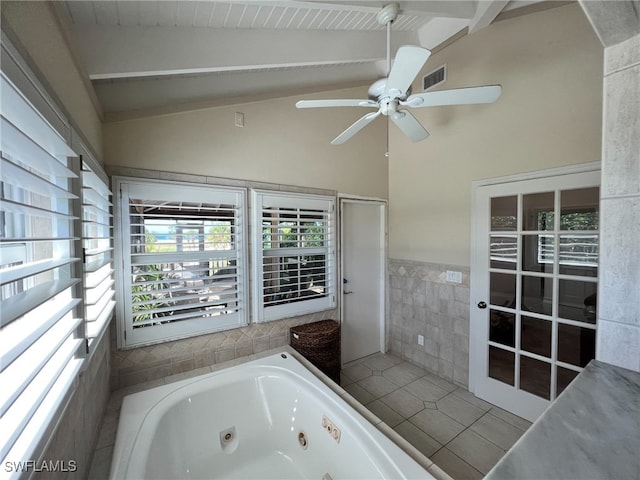 bathroom featuring ceiling fan, tile walls, tile patterned flooring, vaulted ceiling with beams, and a tub