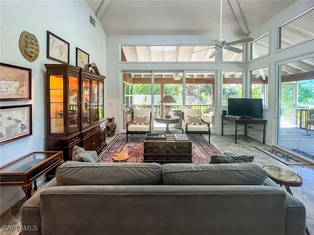 sunroom / solarium with beam ceiling and ceiling fan