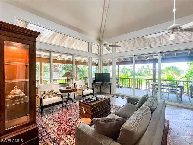 sunroom featuring vaulted ceiling, ceiling fan, and a healthy amount of sunlight