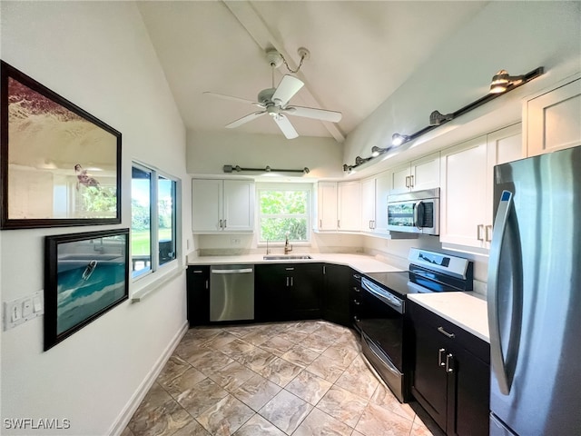 kitchen featuring white cabinetry, sink, ceiling fan, stainless steel appliances, and vaulted ceiling