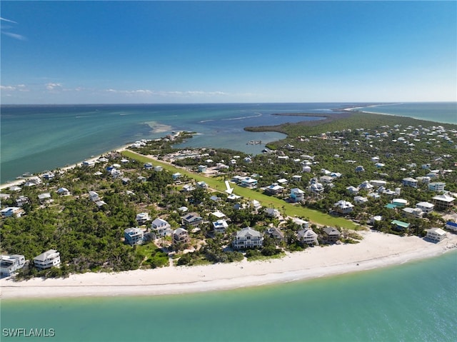 birds eye view of property with a water view and a view of the beach