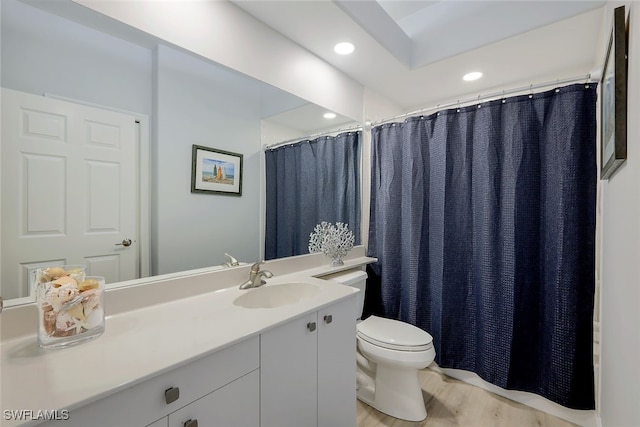 bathroom with vanity, hardwood / wood-style flooring, and toilet