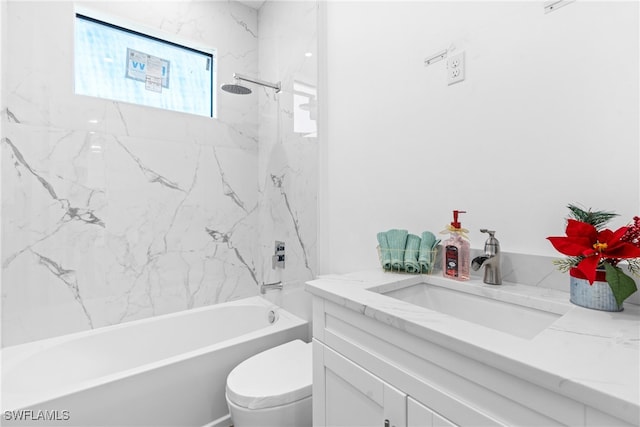 full bathroom with vanity, toilet, and tiled shower / bath