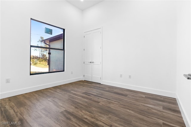 spare room with dark hardwood / wood-style flooring