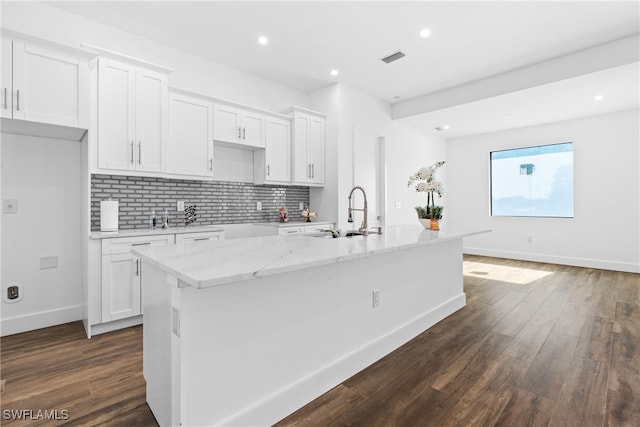 kitchen featuring sink, white cabinetry, an island with sink, and dark wood-type flooring