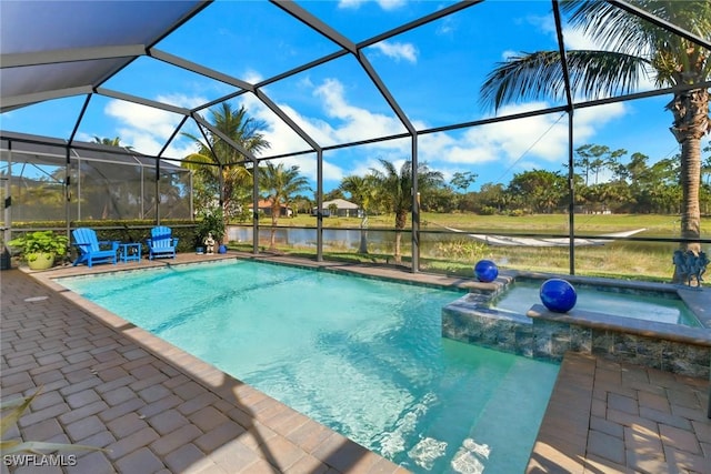 view of pool with a water view, a patio area, glass enclosure, and an in ground hot tub