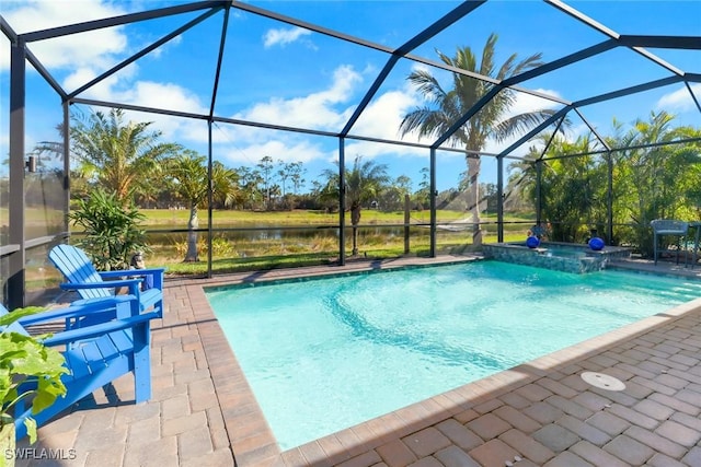 view of pool with glass enclosure, a water view, and a patio