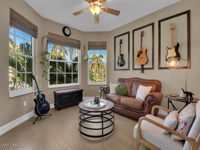 living room featuring light hardwood / wood-style floors and ceiling fan