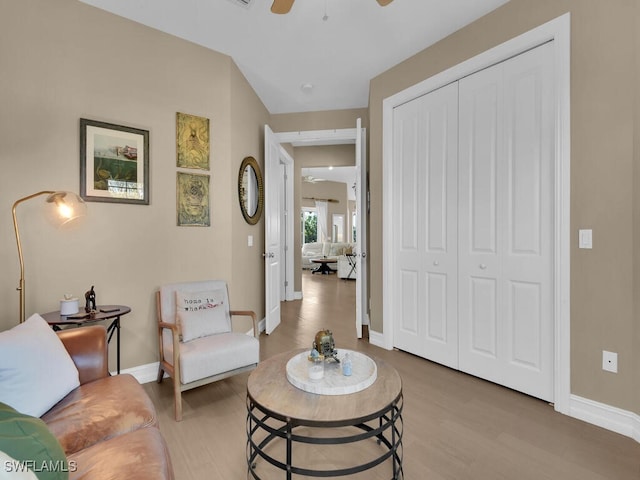 living room with ceiling fan and hardwood / wood-style flooring