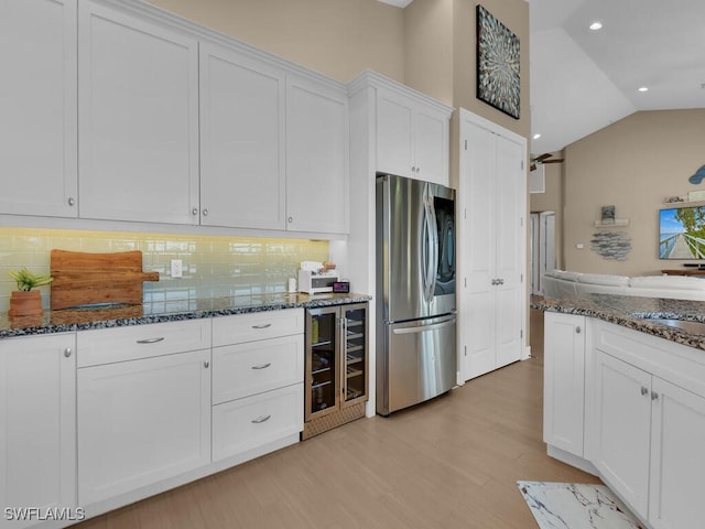 kitchen with wine cooler, stainless steel fridge, tasteful backsplash, light hardwood / wood-style floors, and white cabinetry