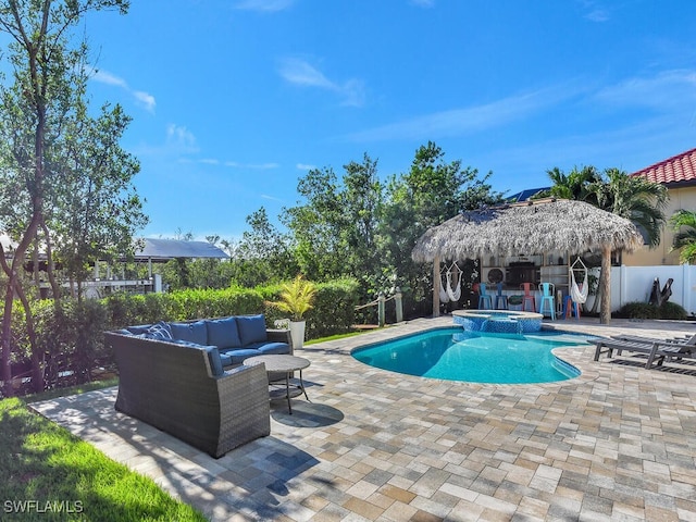 view of swimming pool with an outdoor living space, an in ground hot tub, and a patio