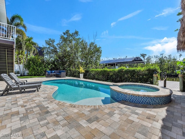 view of swimming pool with a patio area, an in ground hot tub, and an outdoor hangout area