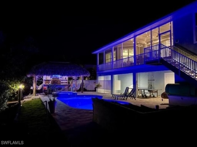 pool at twilight with a patio