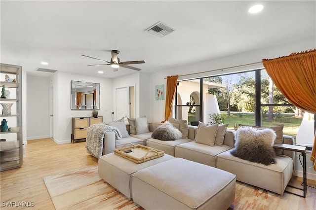 living room featuring ceiling fan and light hardwood / wood-style flooring