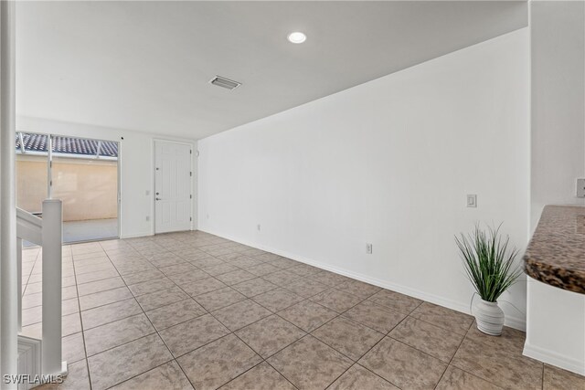 empty room with light tile patterned floors