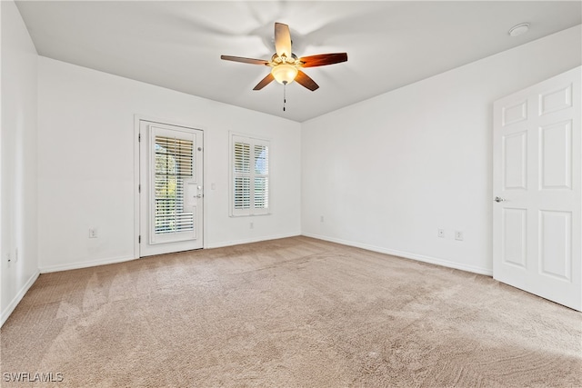 unfurnished room featuring ceiling fan and carpet