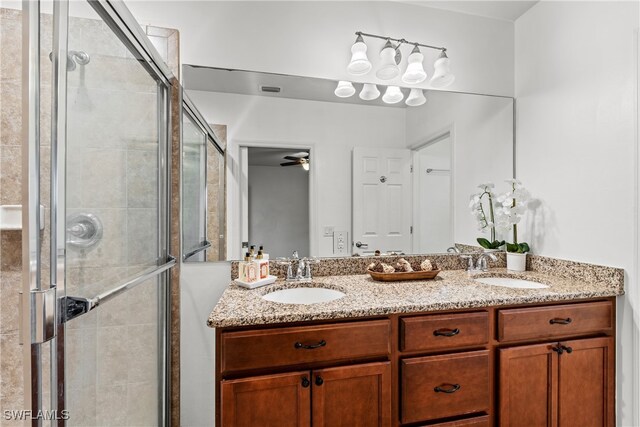 bathroom with vanity, ceiling fan, and a shower with shower door