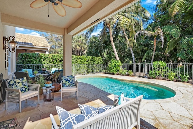 view of swimming pool with ceiling fan and a patio