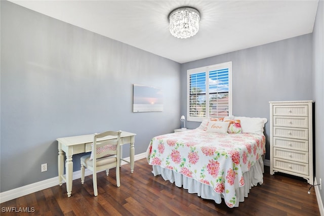 bedroom featuring a notable chandelier and dark hardwood / wood-style flooring