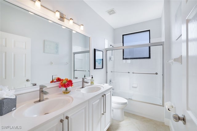 full bathroom with combined bath / shower with glass door, plenty of natural light, toilet, and vanity