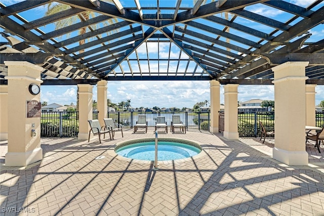 view of swimming pool featuring a community hot tub, a patio area, a water view, and a pergola