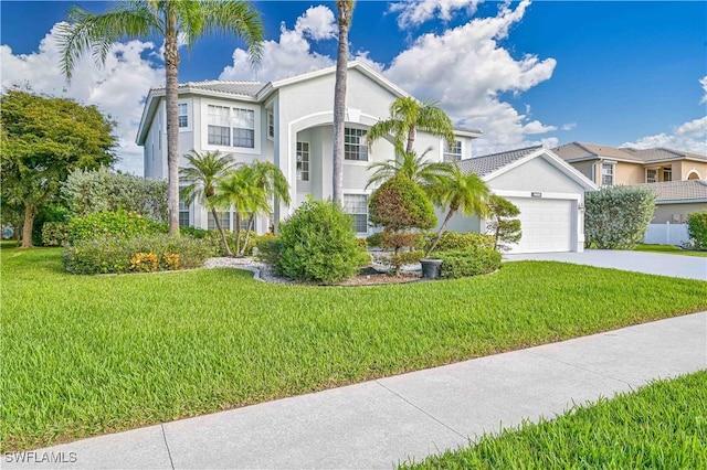 view of front facade featuring driveway, an attached garage, and a front lawn