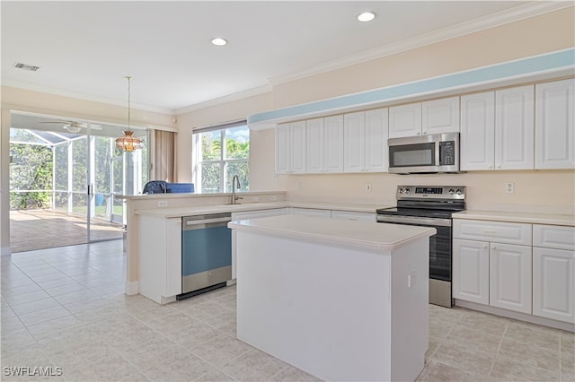 kitchen with visible vents, a center island, light countertops, ornamental molding, and appliances with stainless steel finishes