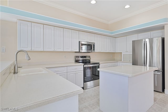 kitchen featuring ornamental molding, a sink, a center island, appliances with stainless steel finishes, and light countertops