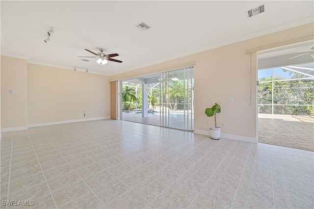 empty room with visible vents, a healthy amount of sunlight, crown molding, and ceiling fan