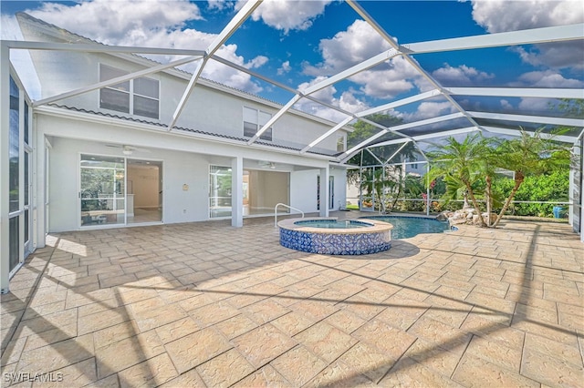 exterior space featuring a pool with connected hot tub, a lanai, a ceiling fan, and a patio area