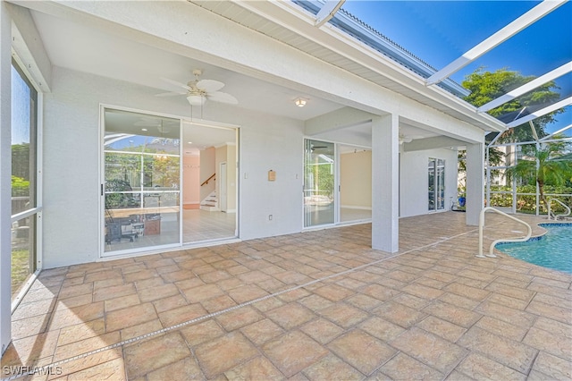 exterior space with beam ceiling and a ceiling fan