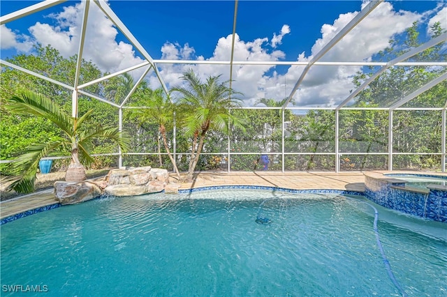 view of swimming pool with a lanai and a pool with connected hot tub