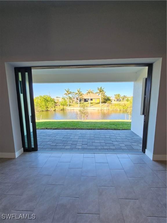 doorway to outside with plenty of natural light and a water view