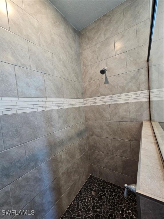 bathroom with a tile shower