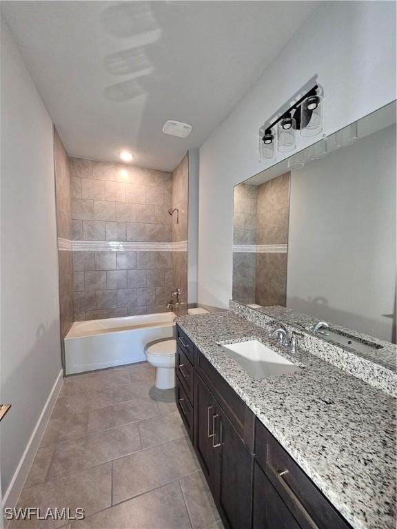 full bathroom with tile patterned floors, vanity, toilet, and tiled shower / bath