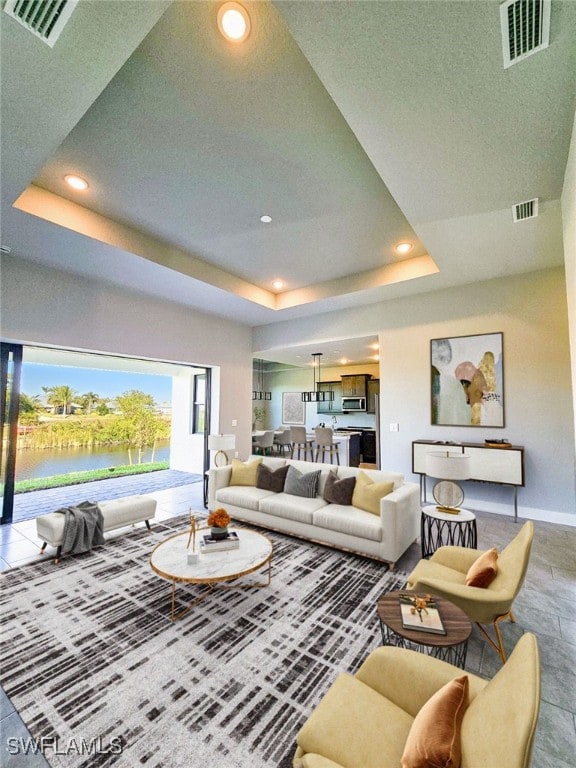 living room featuring a tray ceiling