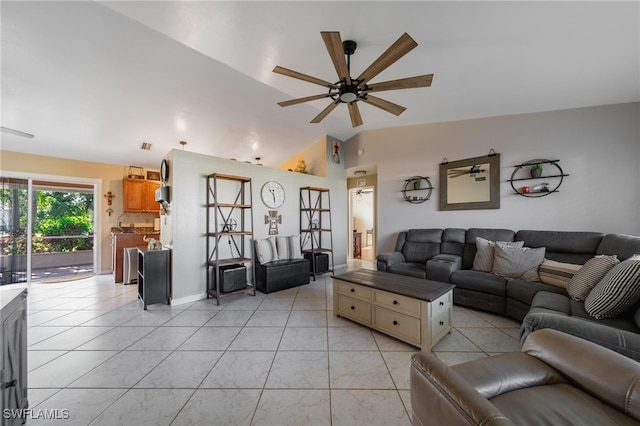 living room with ceiling fan, light tile patterned floors, and vaulted ceiling