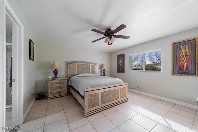 bedroom with ceiling fan, light tile patterned floors, and ensuite bath