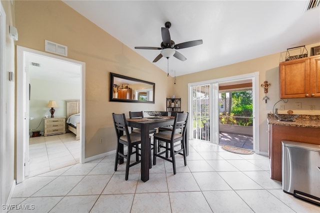 tiled dining room featuring vaulted ceiling and ceiling fan