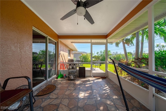 sunroom featuring ceiling fan