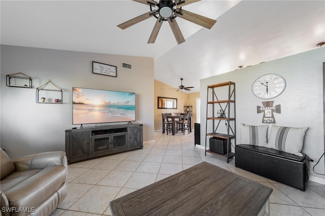 living room with ceiling fan, light tile patterned floors, and vaulted ceiling