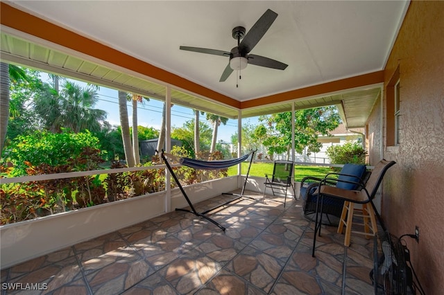 sunroom / solarium with a wealth of natural light and ceiling fan