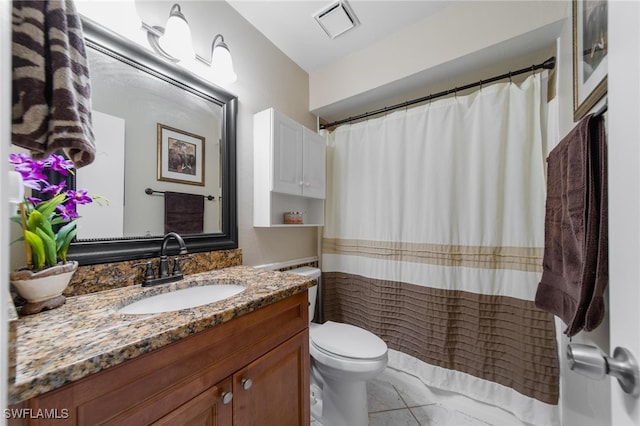 bathroom featuring tile patterned floors, vanity, and toilet