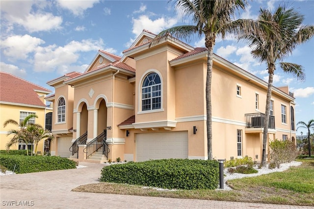 mediterranean / spanish home featuring a garage