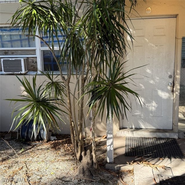 entrance to property featuring cooling unit