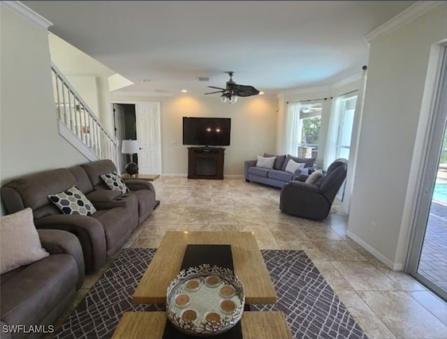 living room featuring ceiling fan and ornamental molding