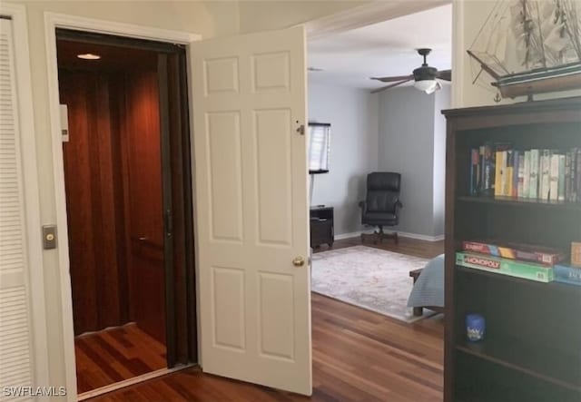 hall with dark hardwood / wood-style floors